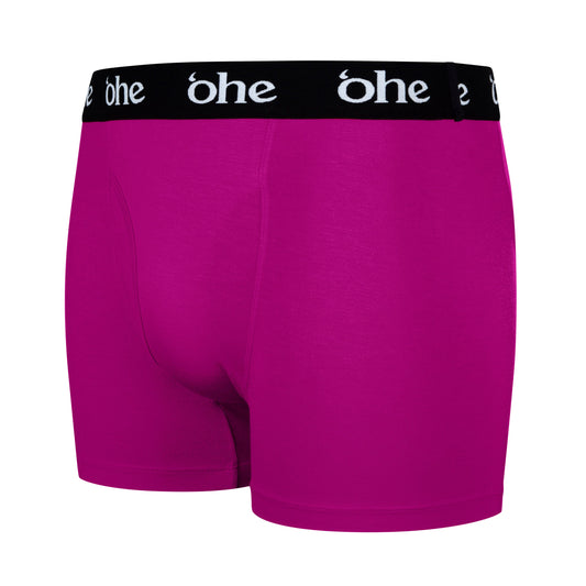 Diagonal view of purple/magenta men's bamboo underwear boxer shorts with black waist band and white 'ohe logo