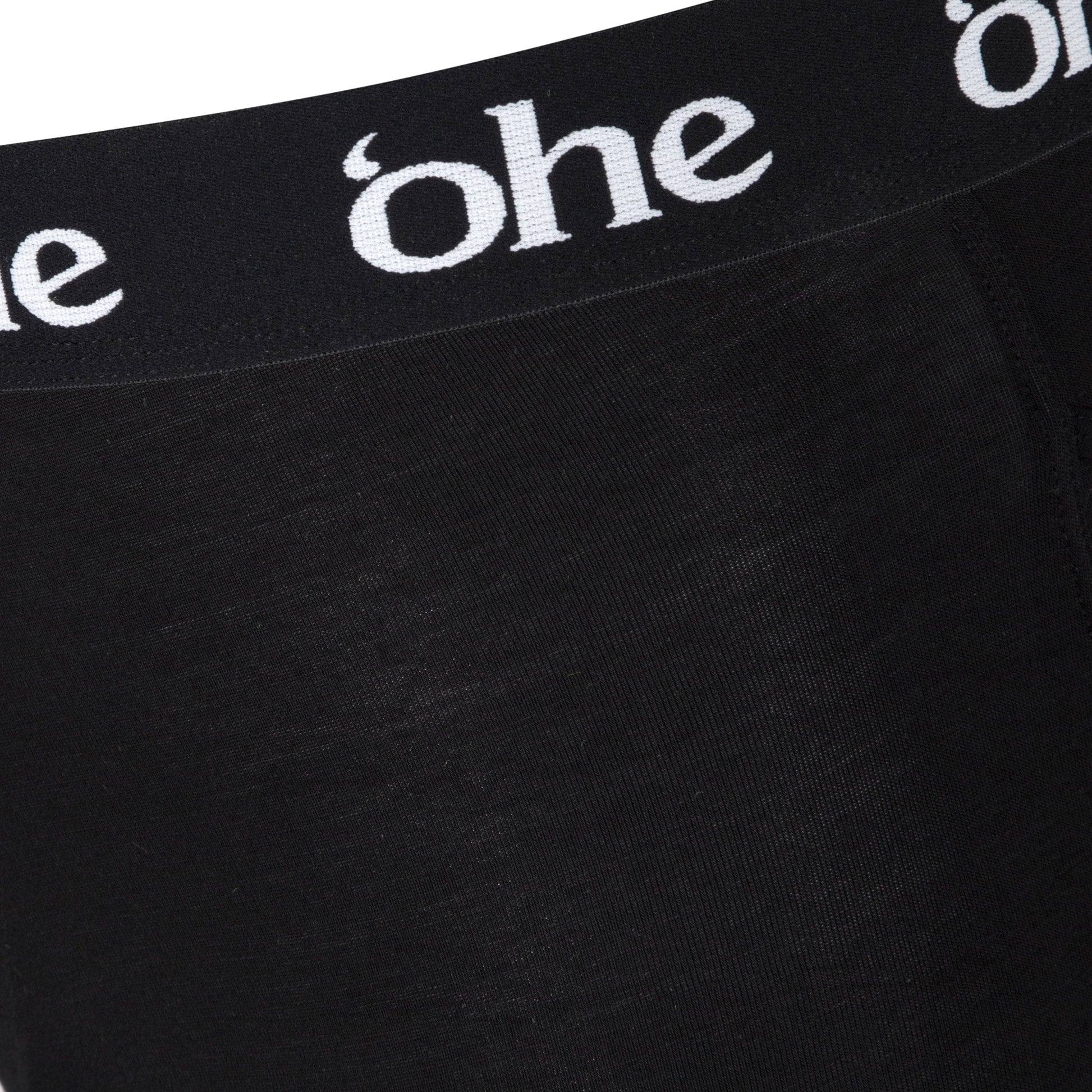 Close up view of waistband on black men's bamboo boxer shorts from 'ohe