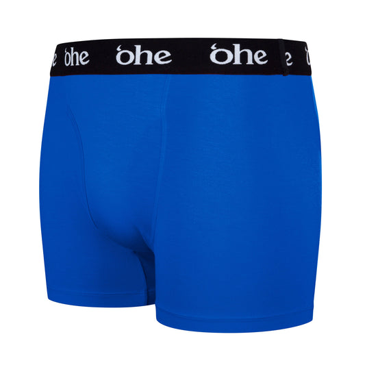 Diagonal view of blue men's bamboo underwear boxer shorts with black waist band and white 'ohe logo